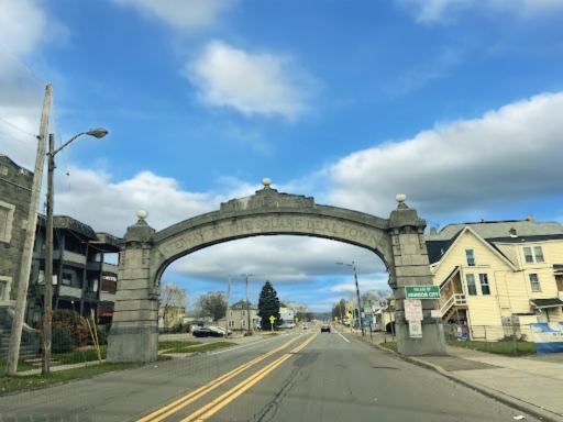 Entrance way to Johnson City, New York, which reads "Gateway to the Square Deal Towns"