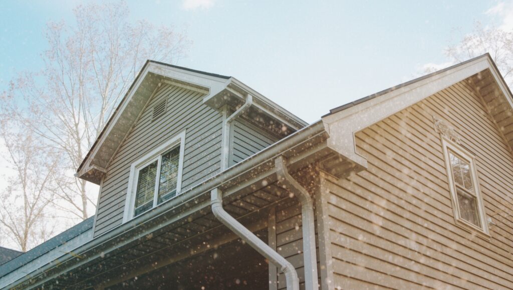 Well-maintained residential roof and gutter system in New York showing year-round protection against weather damage